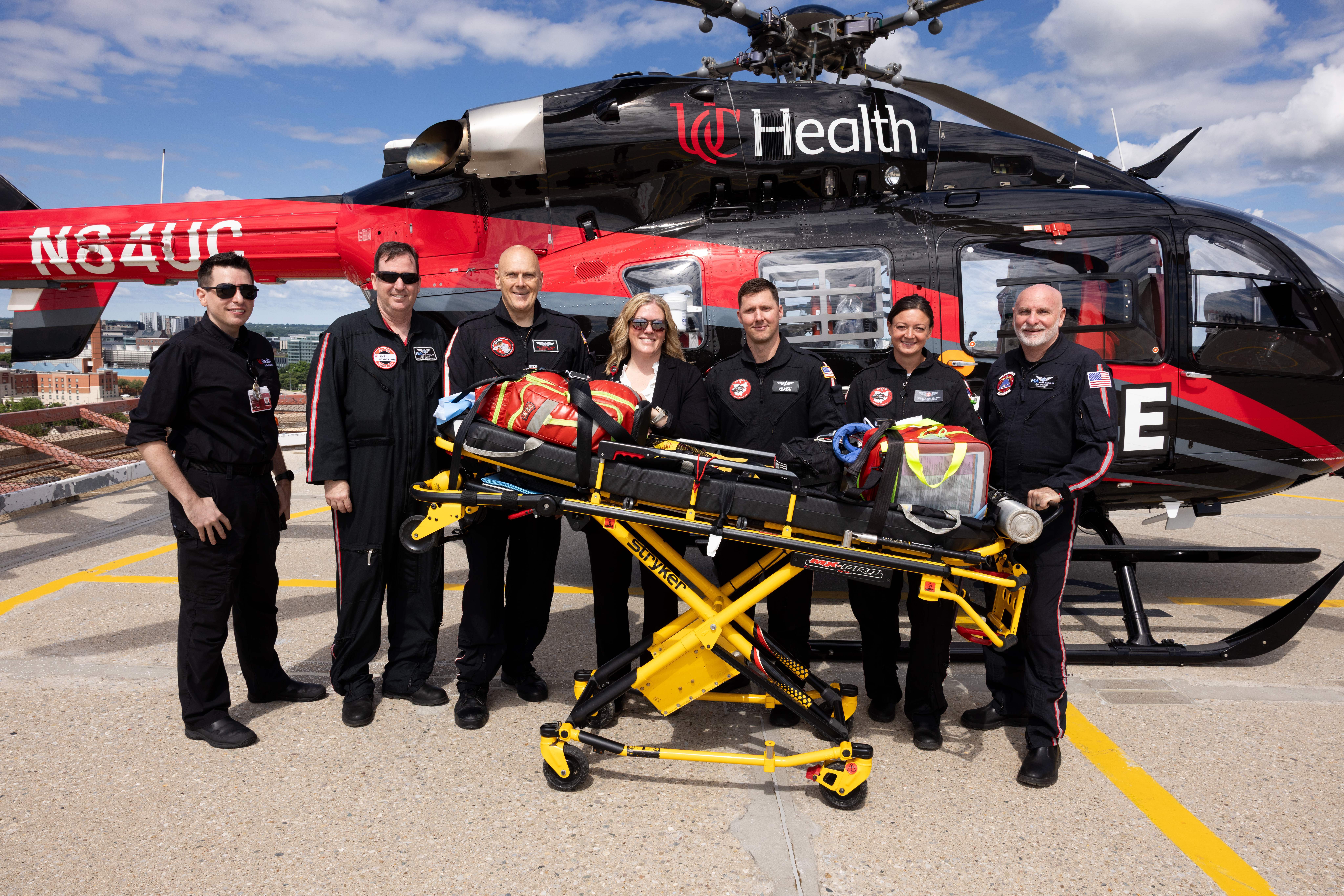 Air Care team, including Kristy Hirt (center), in front of a helicopter on the UCMC helipad.