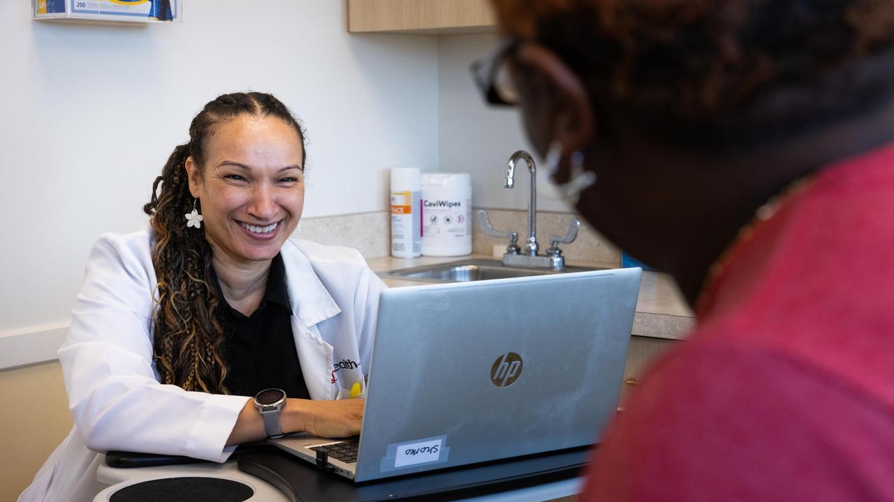 Doctor smiling at a laptop