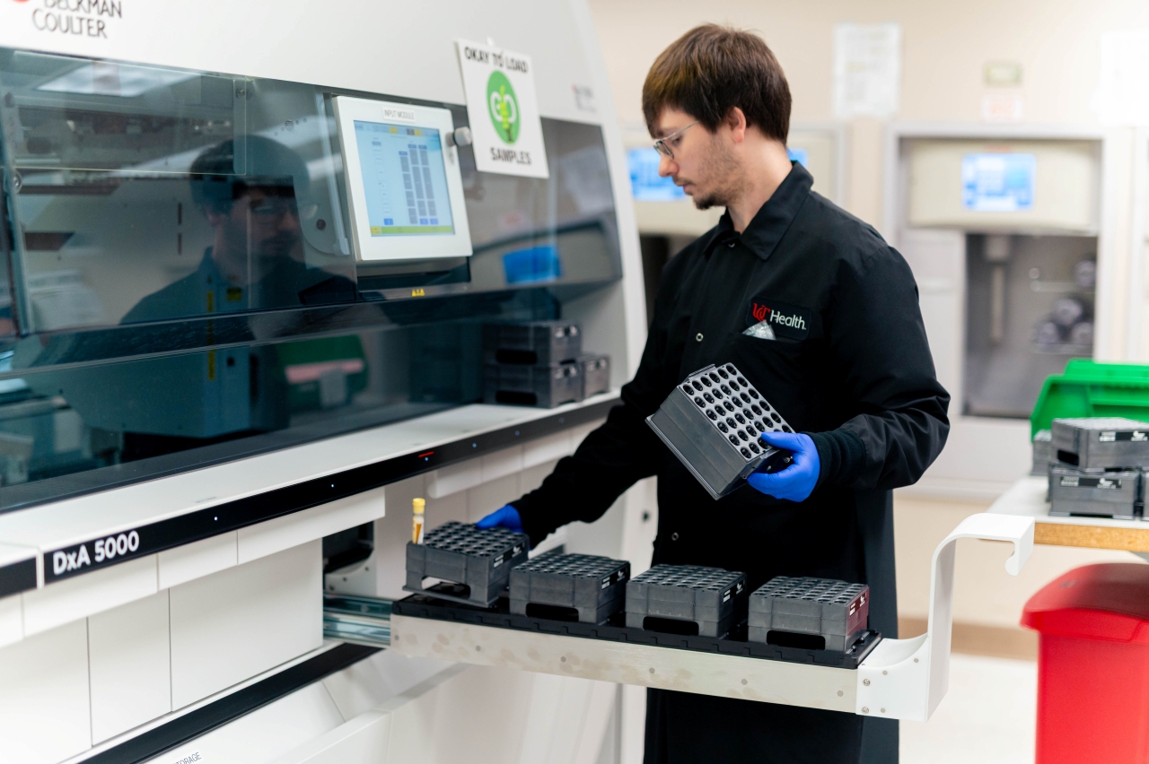 Technician works with equipment in the core lab.