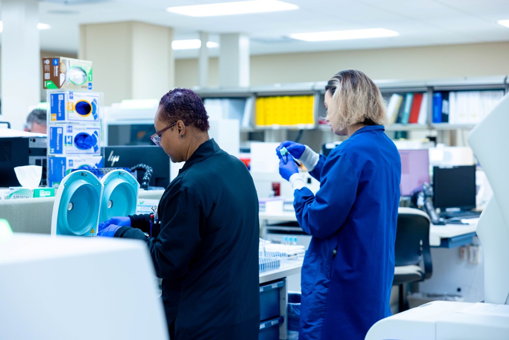 Specialists working with lab equipment. 
