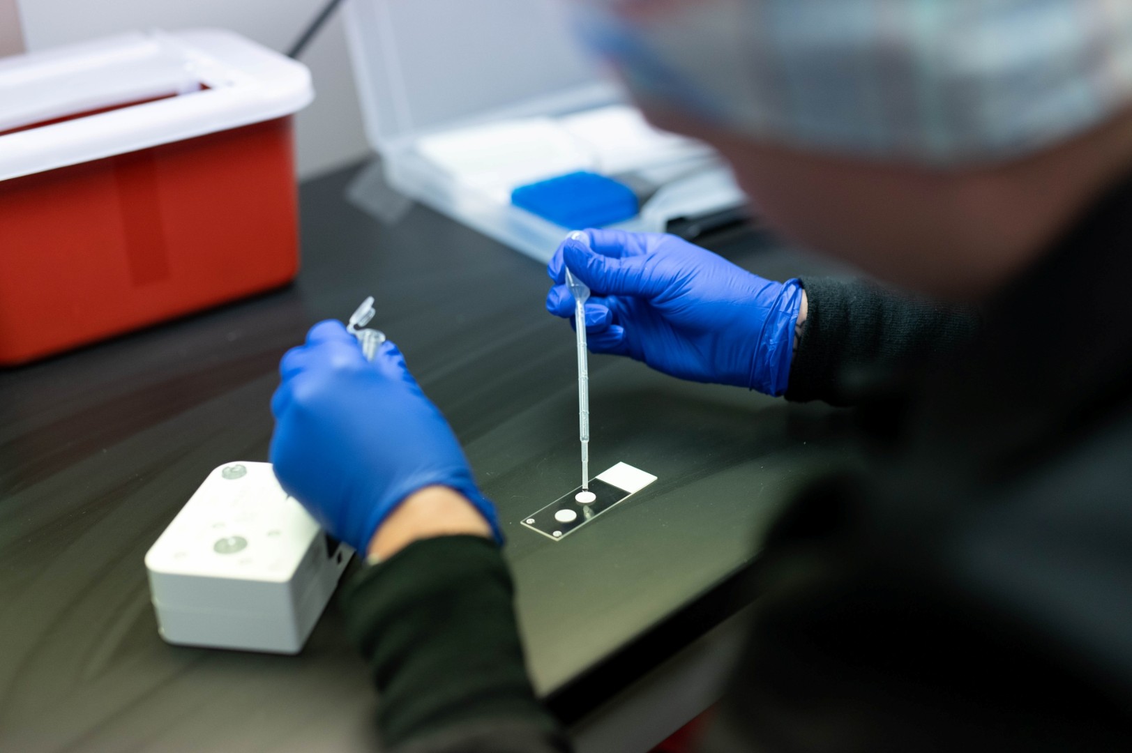Medical provider works with lab equipment.