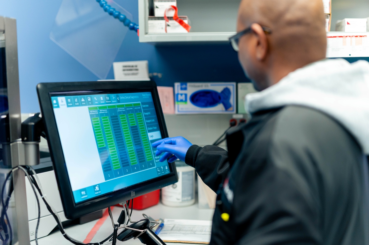 Specialist working in a lab environment on a computer. 