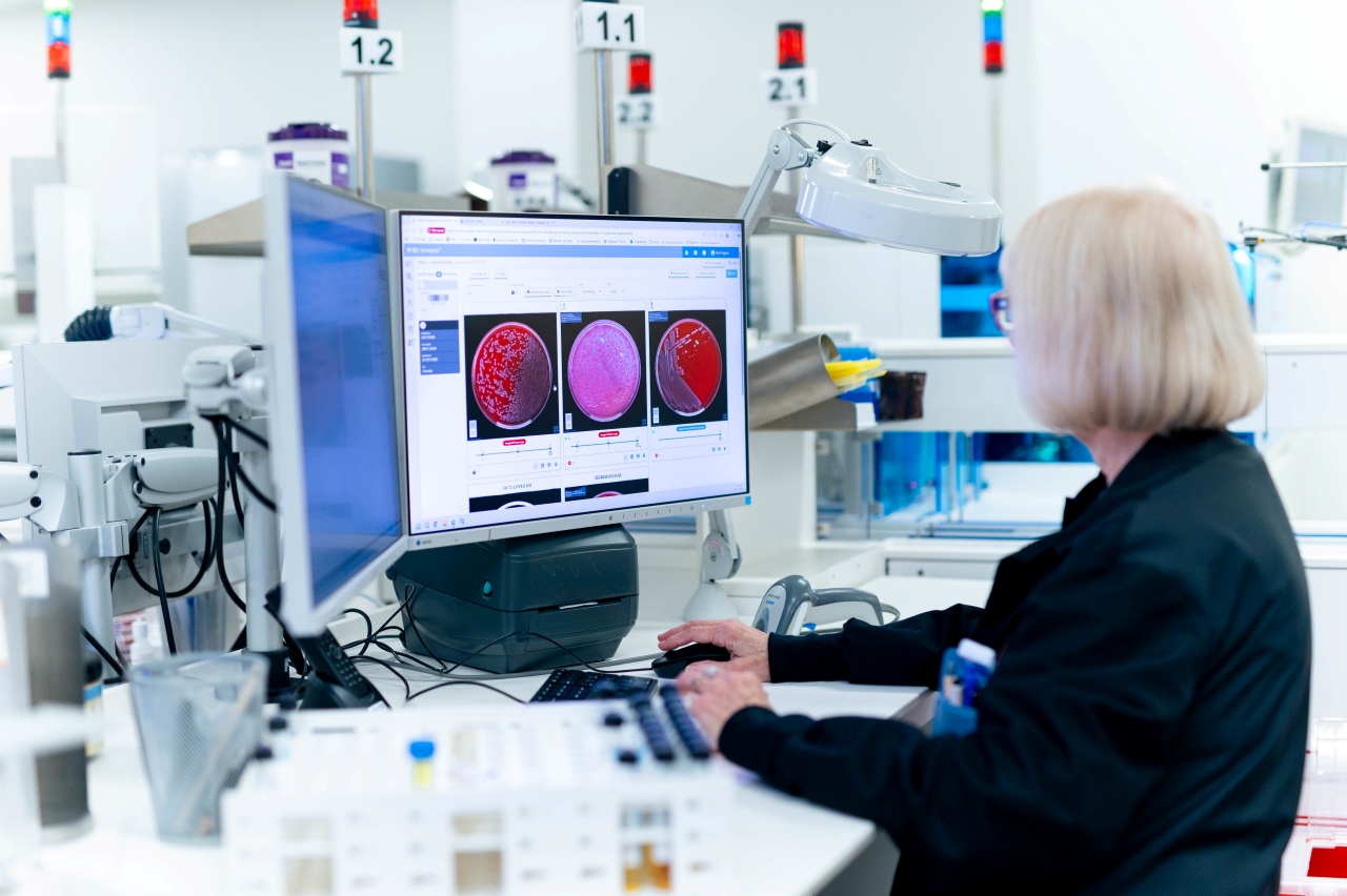 Lab specialist working on a computer. 