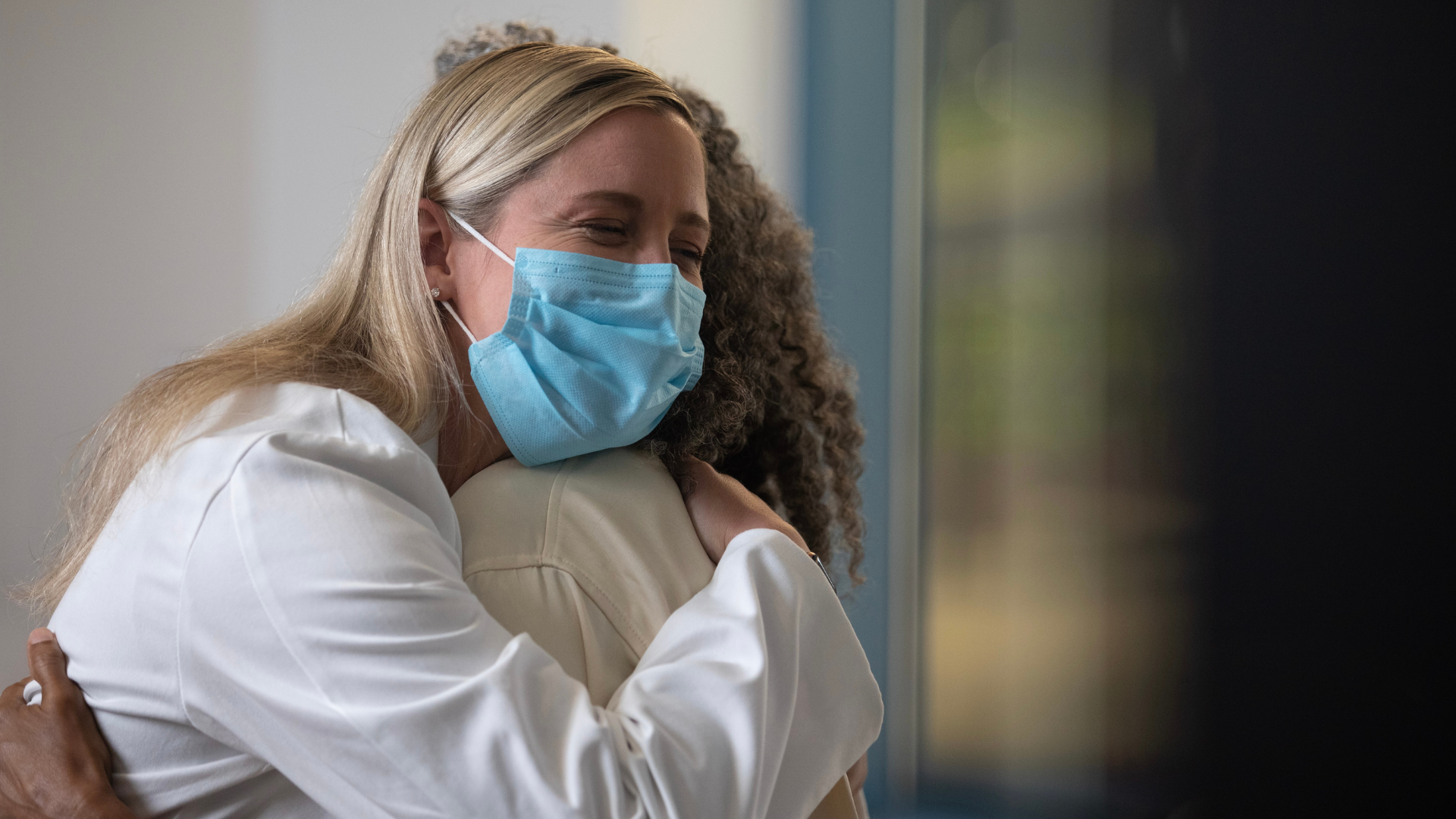 Physician and patient share a hug