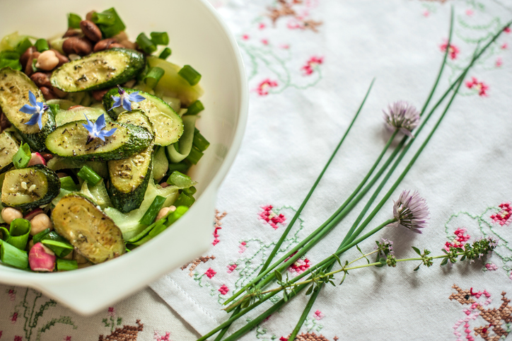 IBD-friendly zucchini dish displayed by flowers.