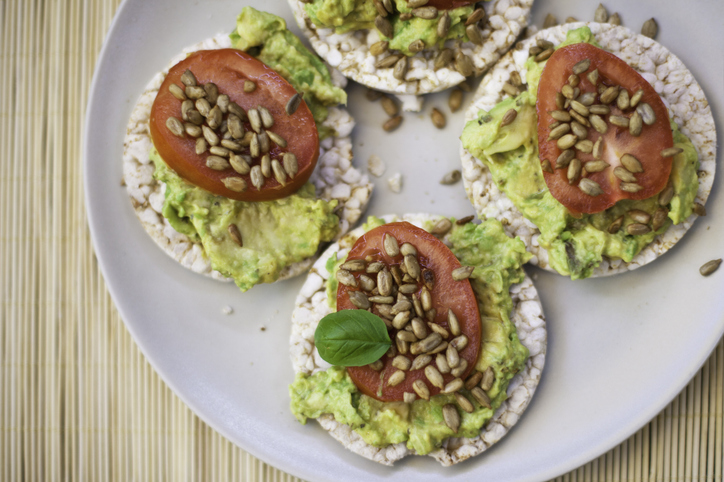 IBD-friendly avocado rice cakes with tomato. Not featured: the recommended hard-boiled egg.