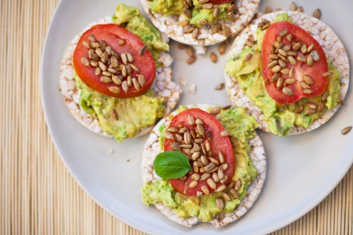 IBD-friendly avocado rice cakes with tomato. Not featured: the recommended hard-boiled egg.