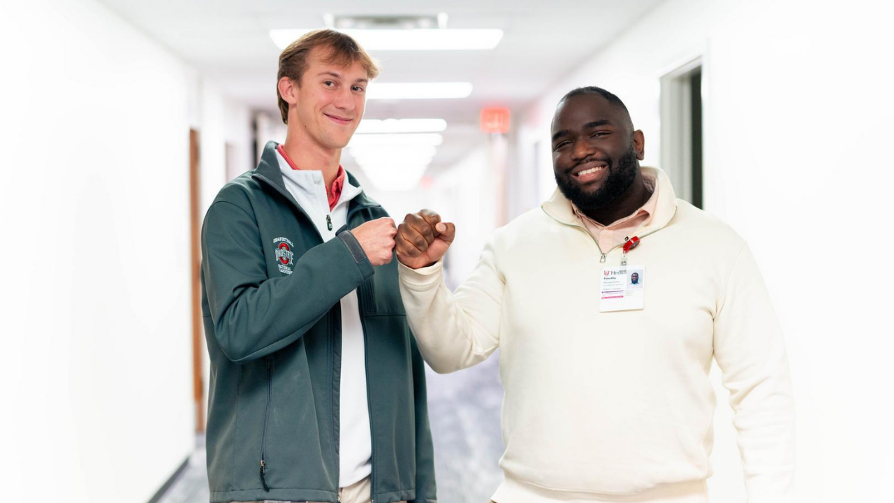 Two co-op students smile in hospital hallway
