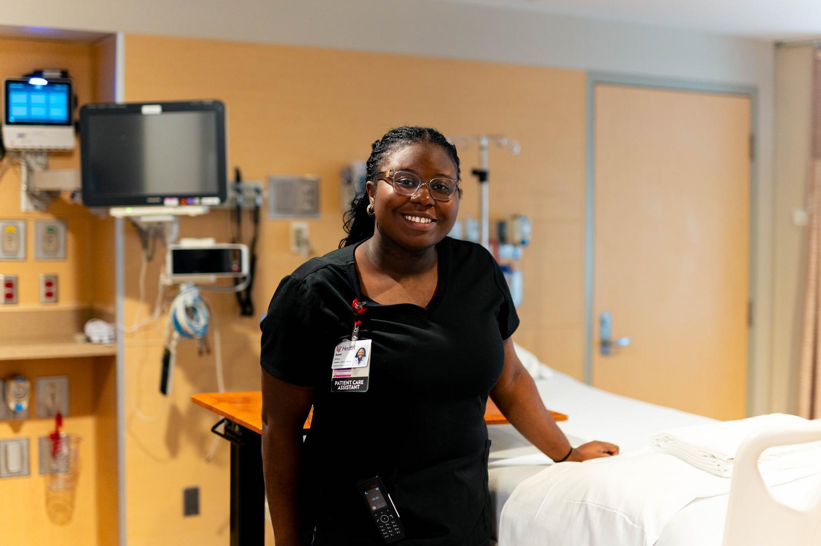 Patient care assistant in patient room