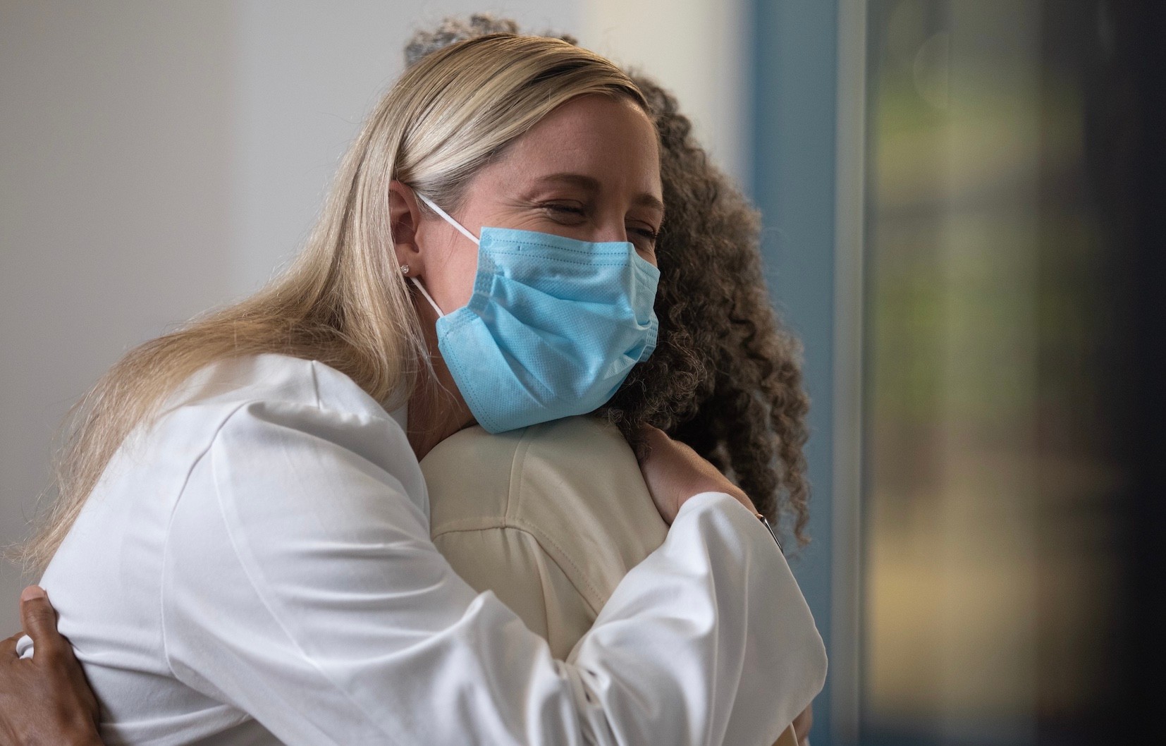 Physician hugs a patient. 