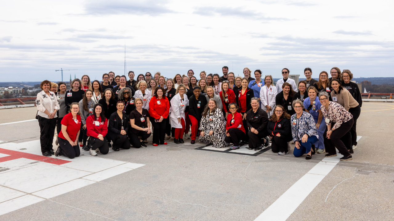 Large group of nurses at UC Health gather for a photo on the helicopter landing pad