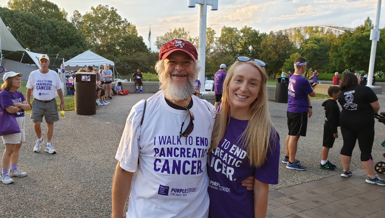 Tim Rice smiling and posing with woman at pancreatic cancer walk.