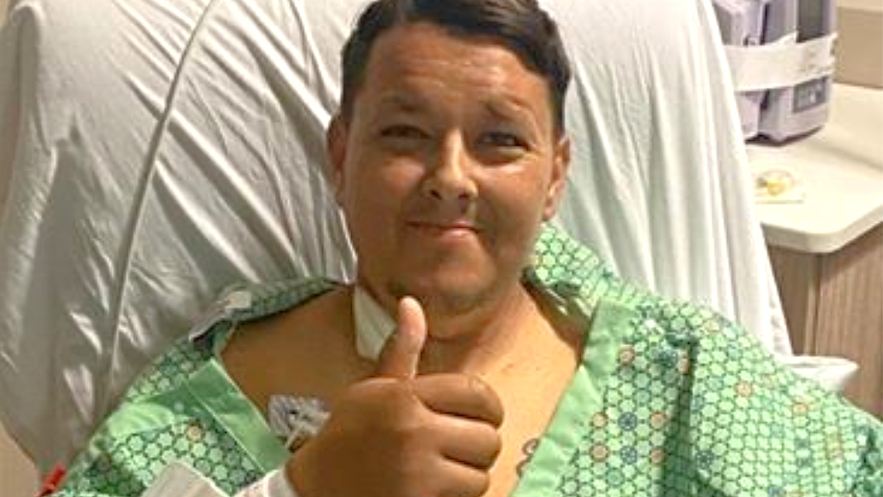 Seth gives the thumbs up sign from his hospital bed. 