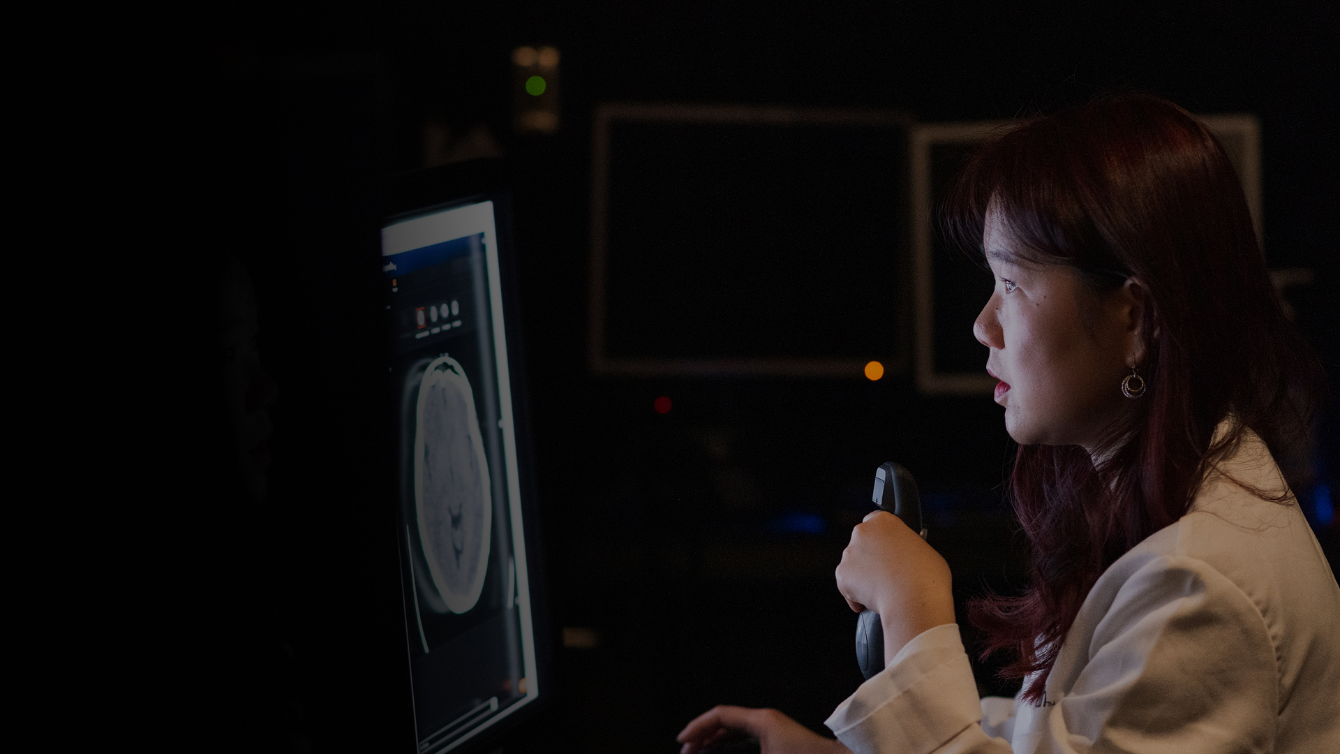 Physisican looks at a computer monitor. 