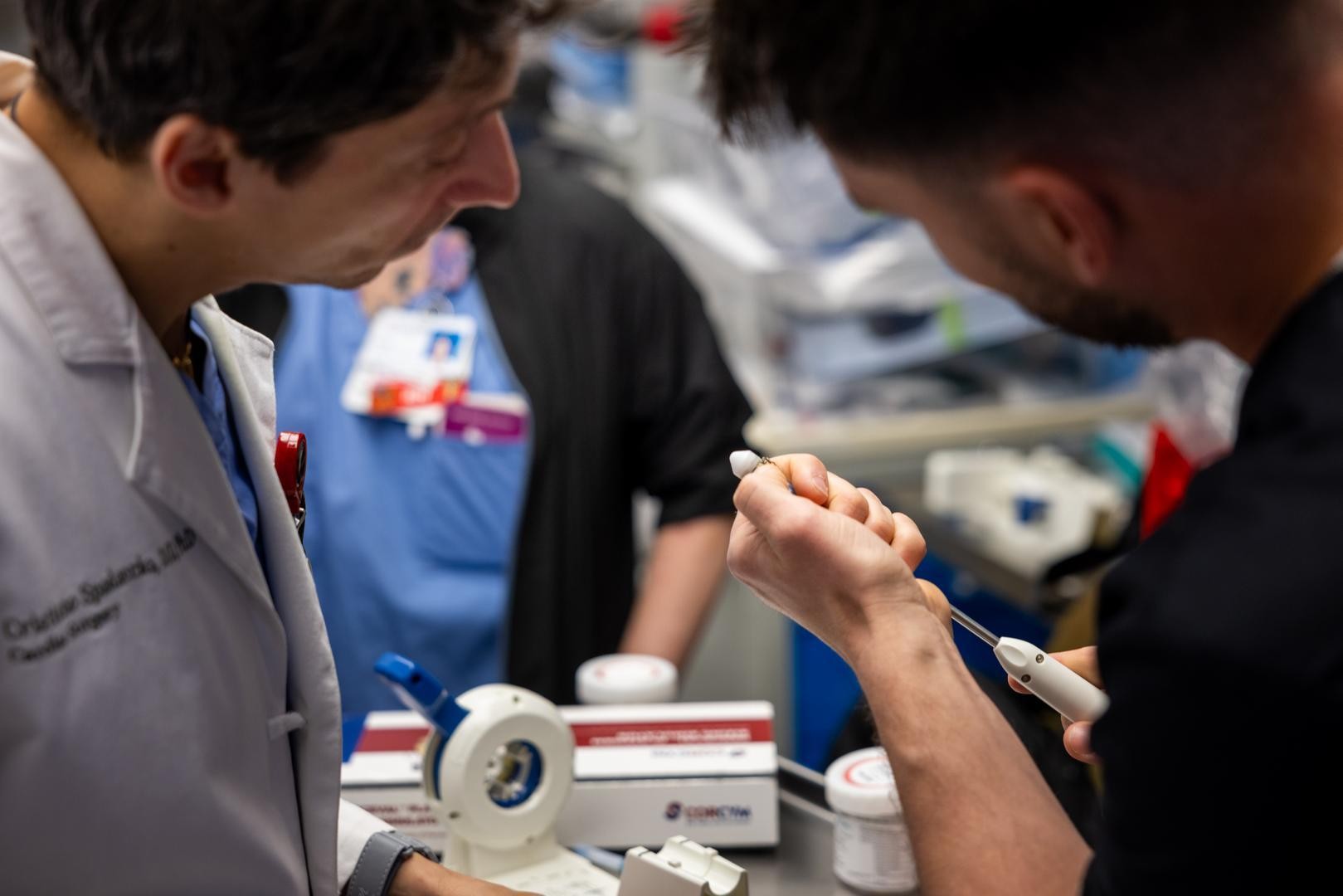 Physicians look at a device. 