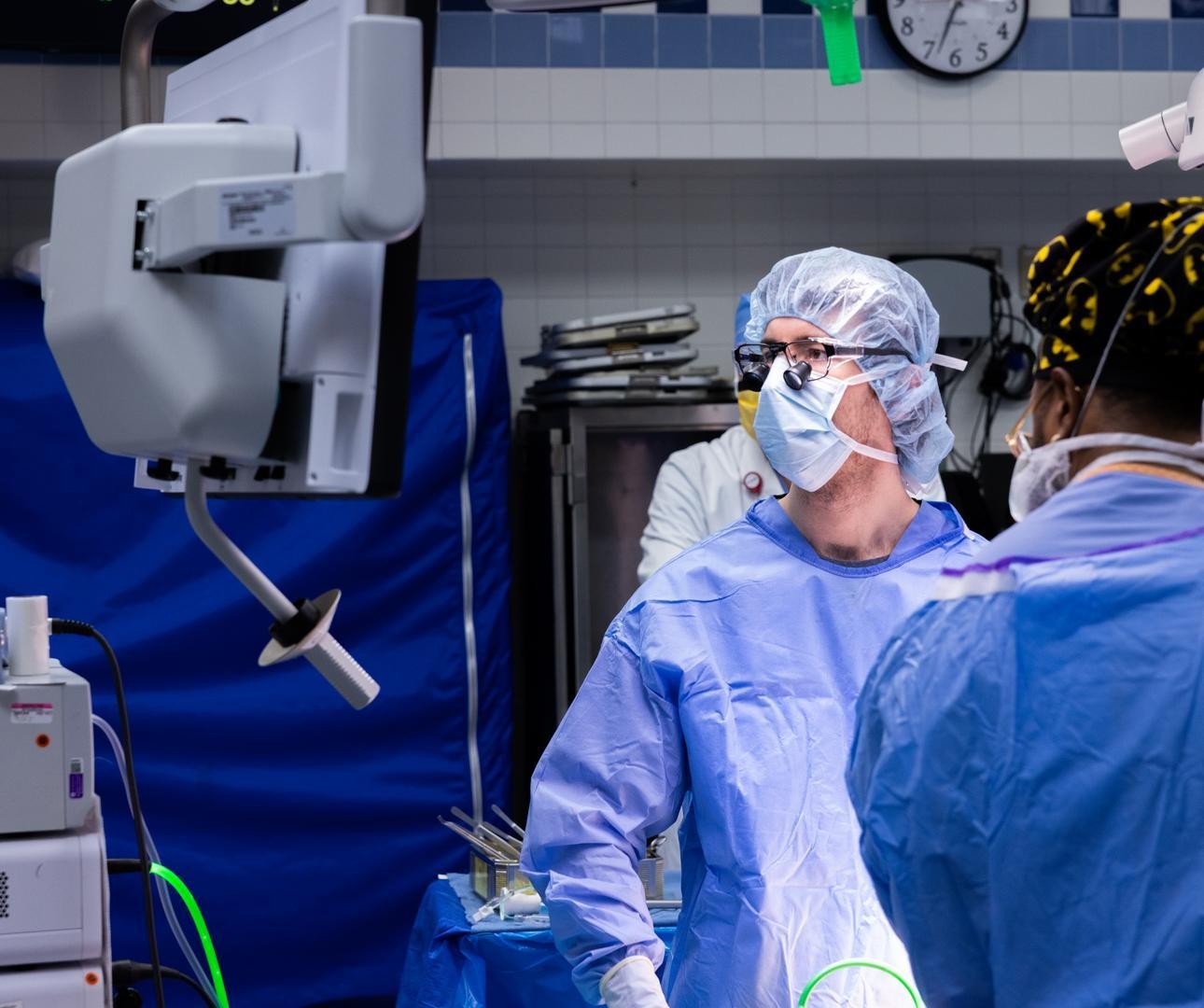 Physician looks at a monitor during a medical procedure.