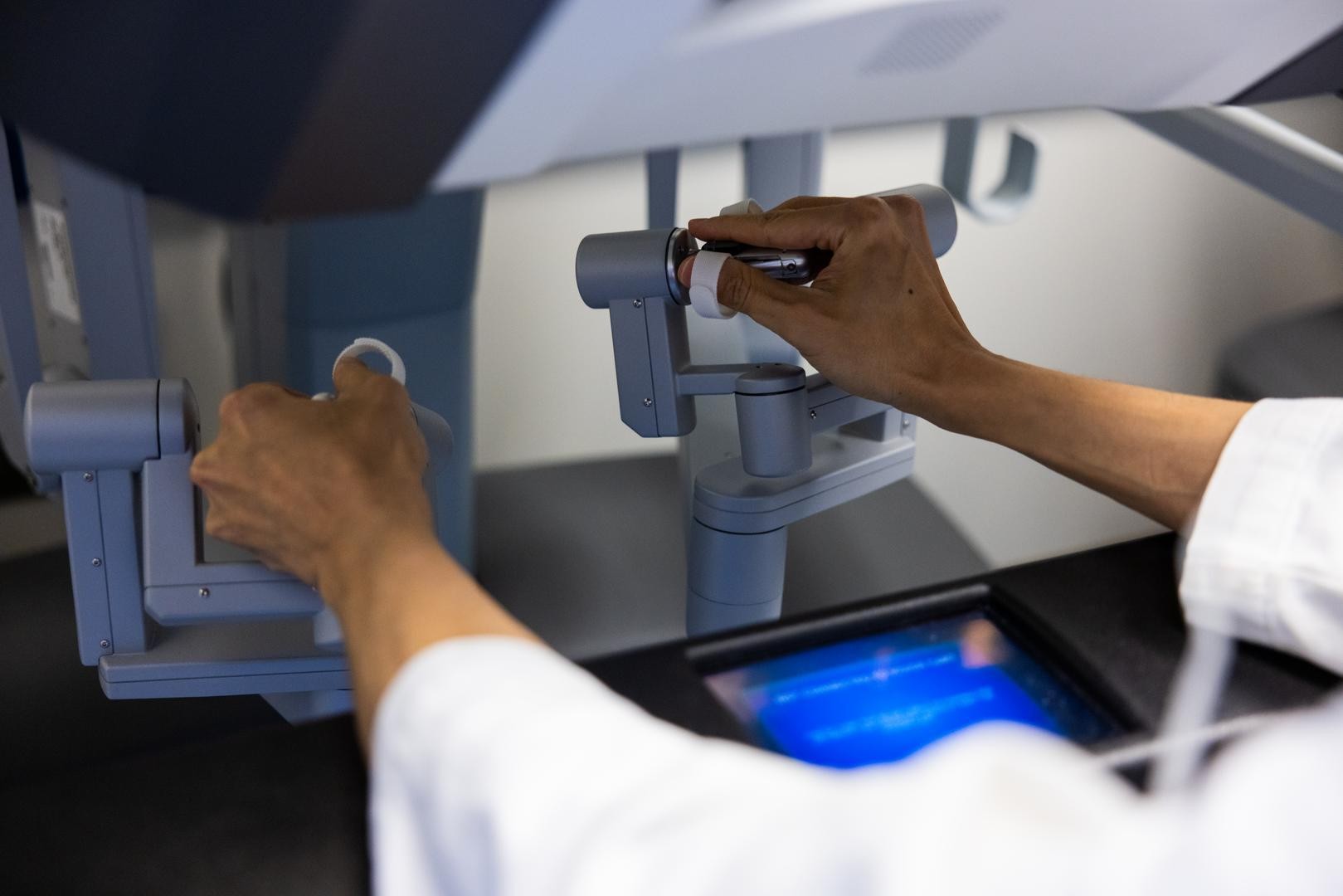 Physician works with a da Vinci 5 robotic surgical device. 