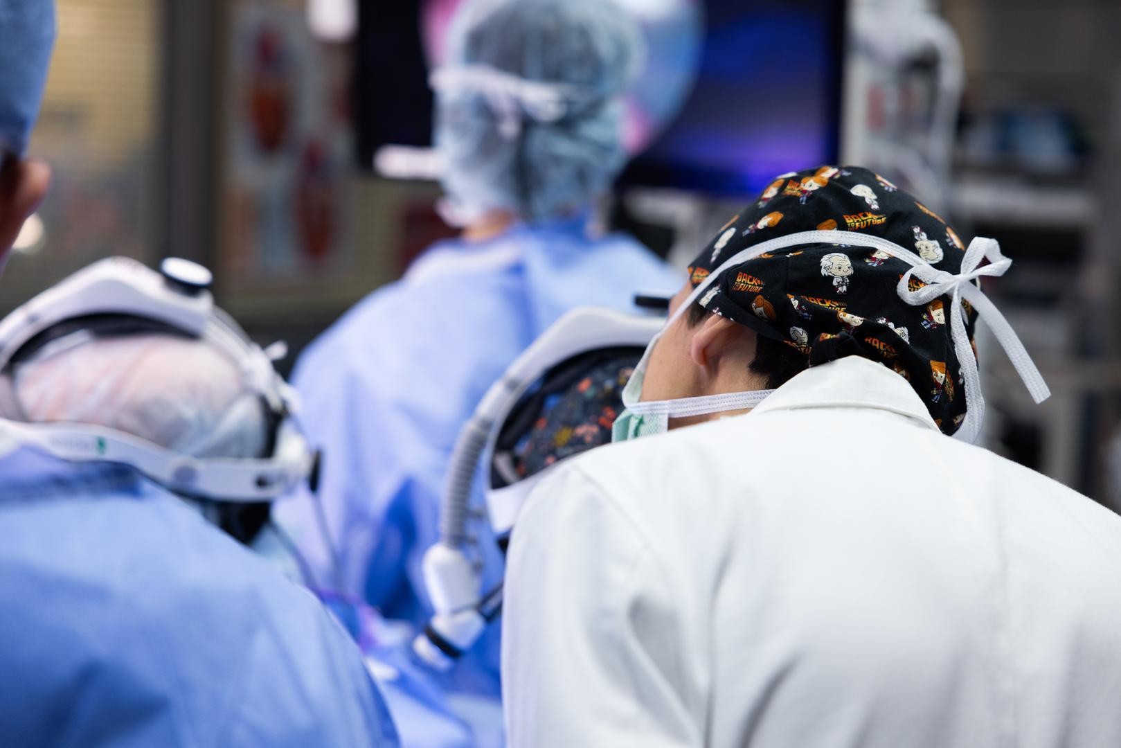 Surgeons perform a medical procedure.