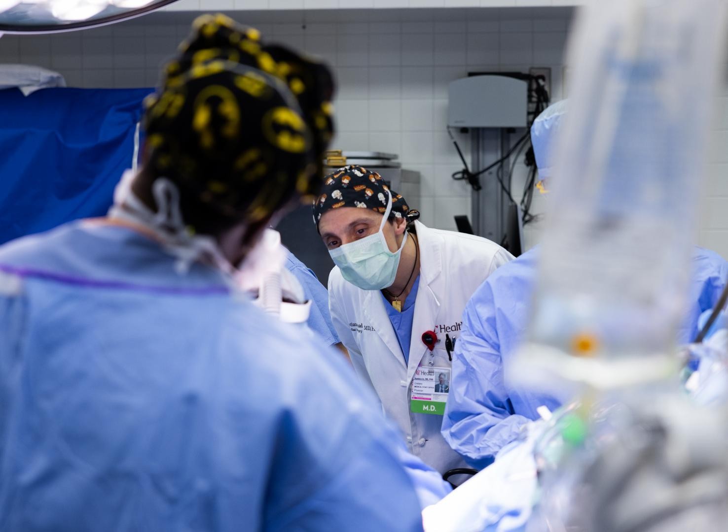 Physicians perform a medical procedure.