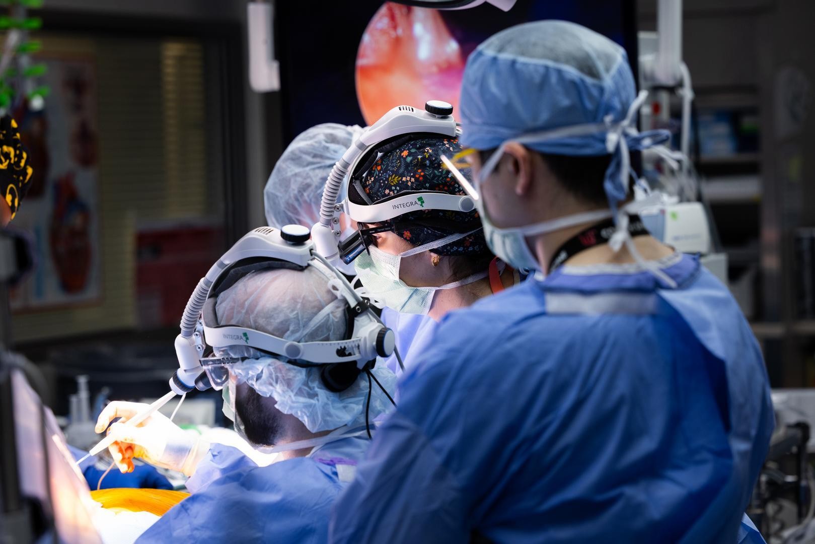 Surgeons perform a medical procedure.