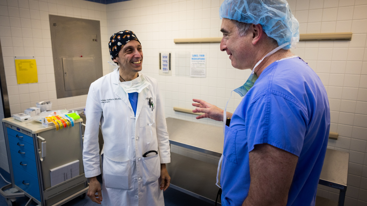 Dr. Spadaccio and Dr. Louis at UC Health talk together in operating room
