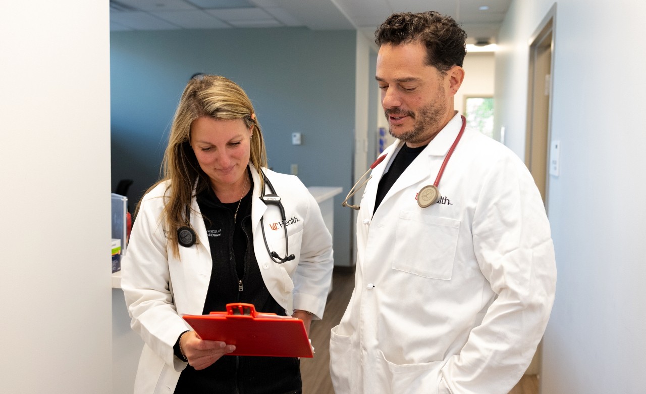Cadiology specialists talk together in hallway