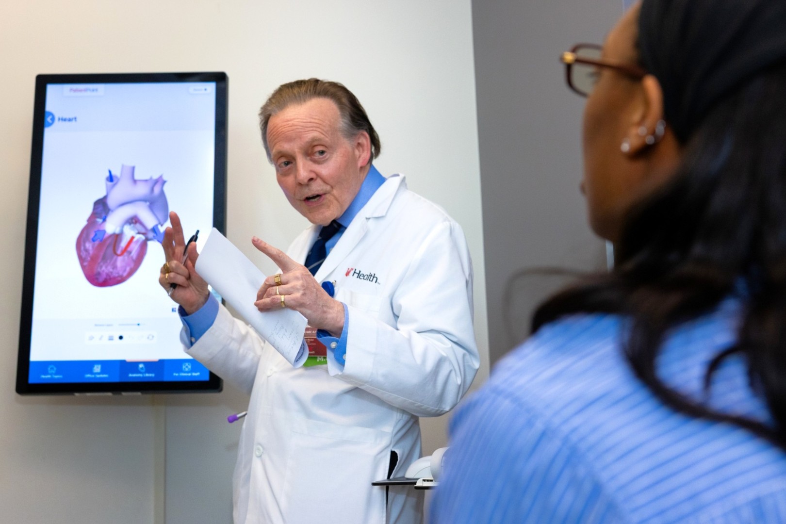 Physician talks with a patient in an medical environment.