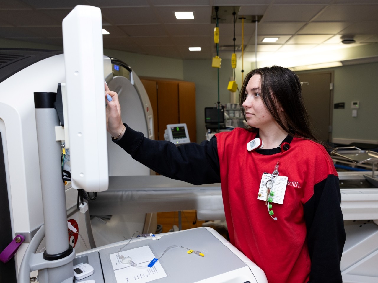 Medical provider checks lab equipment. 