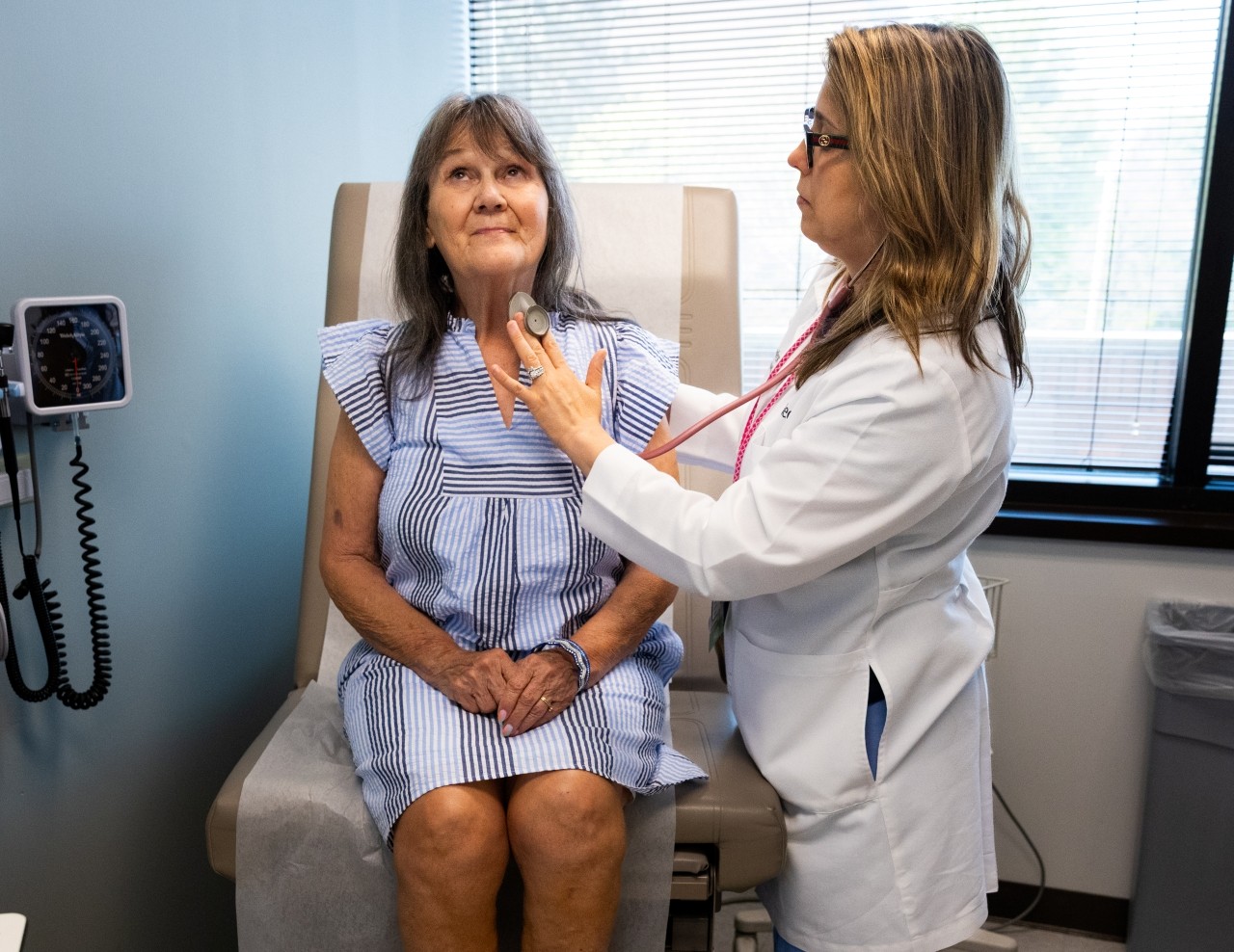 Physician attends to a patient in an exam room. 