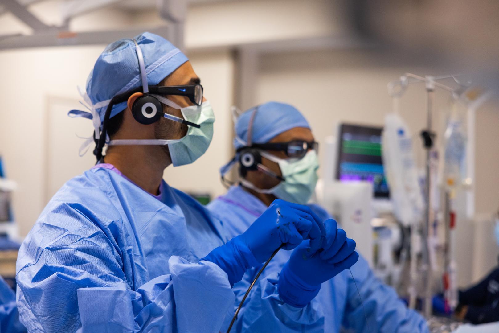 Physicians perform a medical procedure.