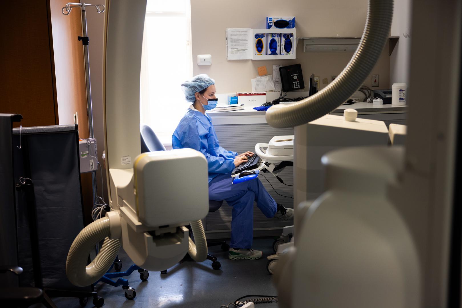 Physician types information into a medical system. 
