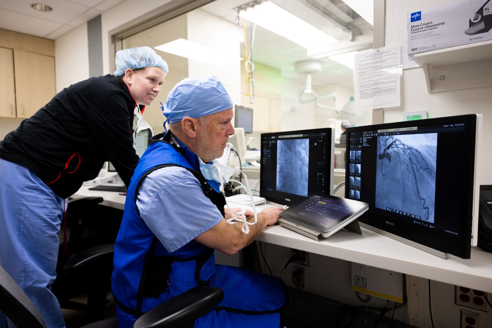 Medical Providers look at a computer monitor.