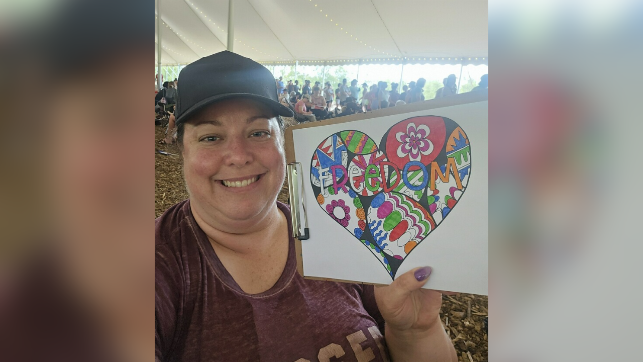 Kristen shows off her "Freedom" artwork