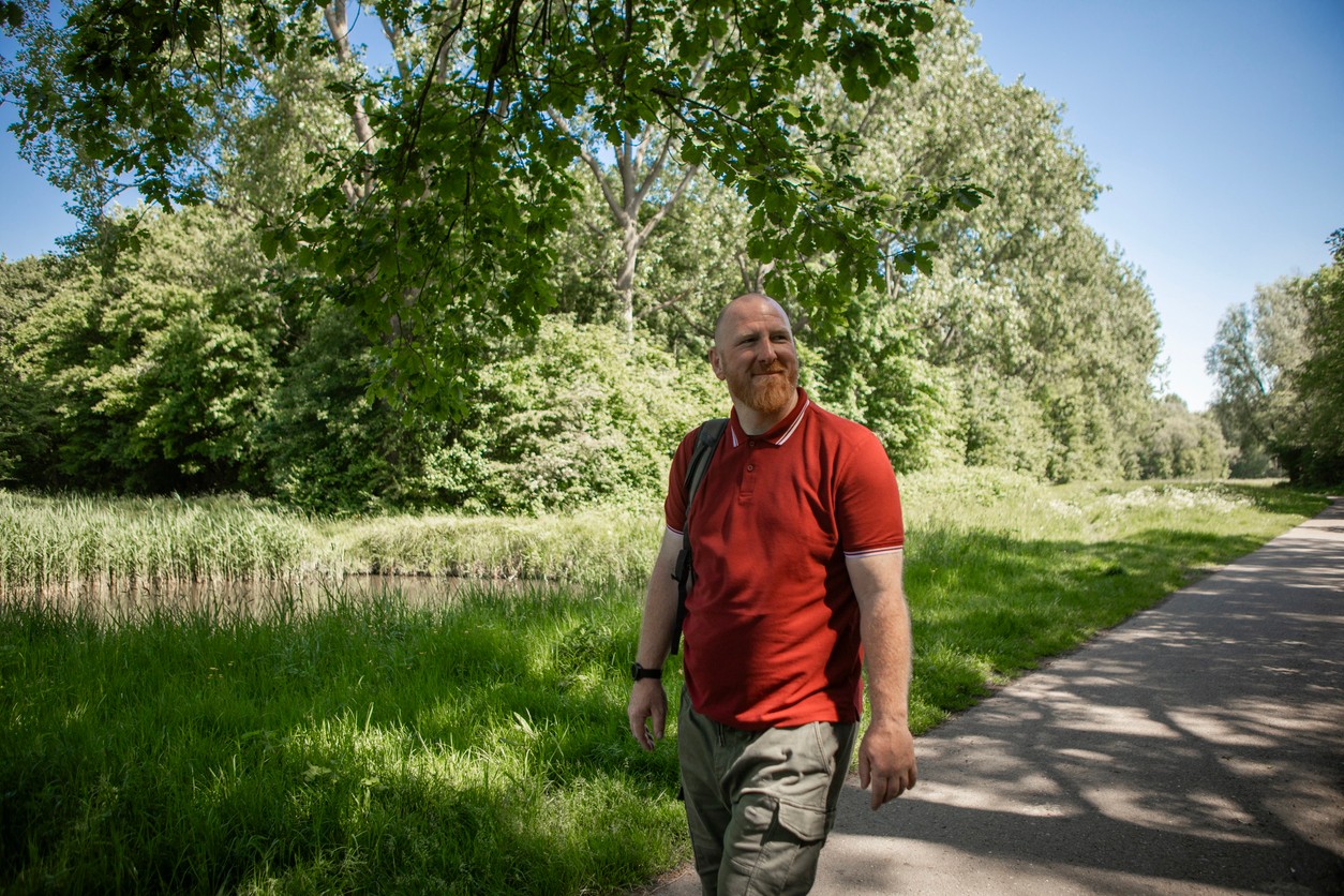 Man walks outside down a path enjoying the day