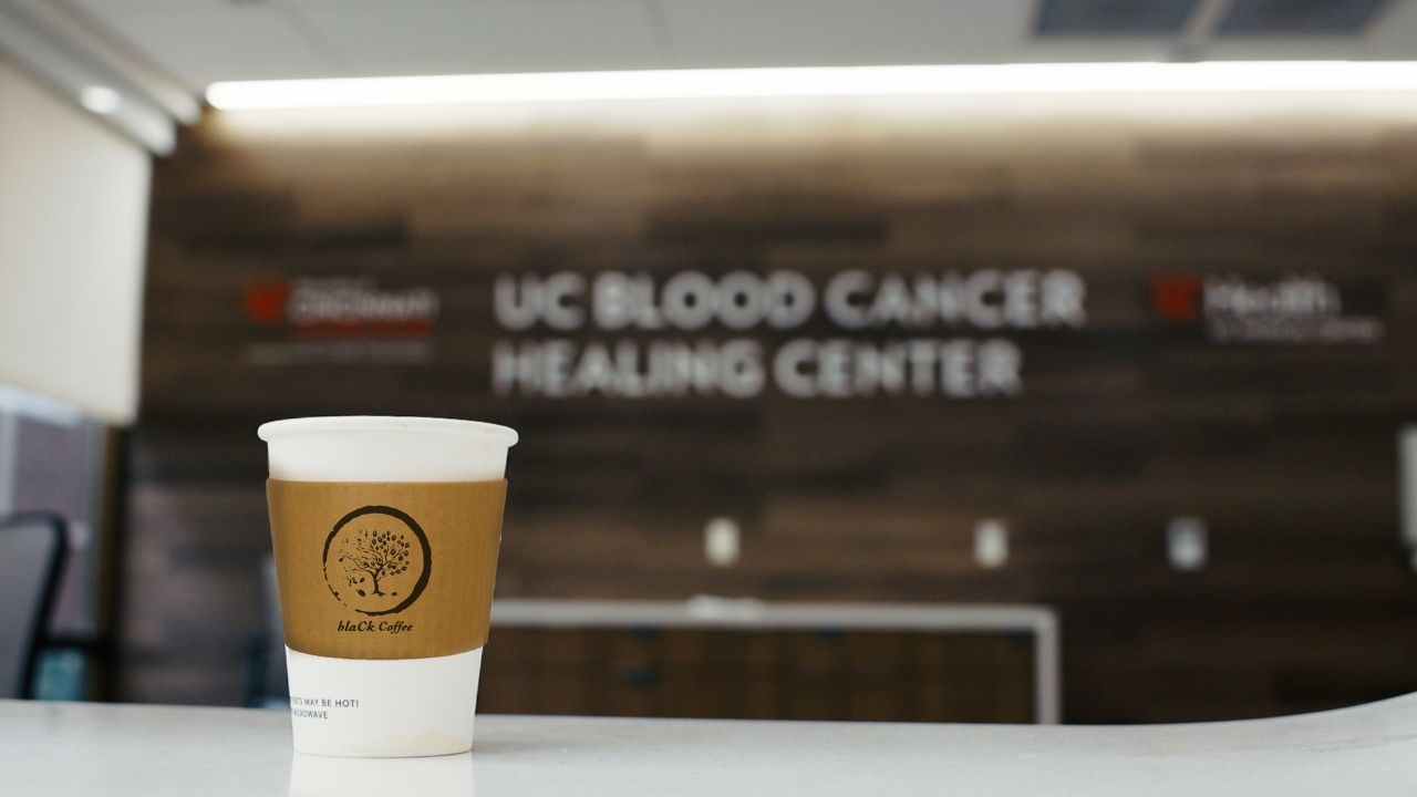 Cup of coffee from the blaCk Coffee Lounge in front of the UC Blood Cancer Healing Center in Cincinnati, Ohio