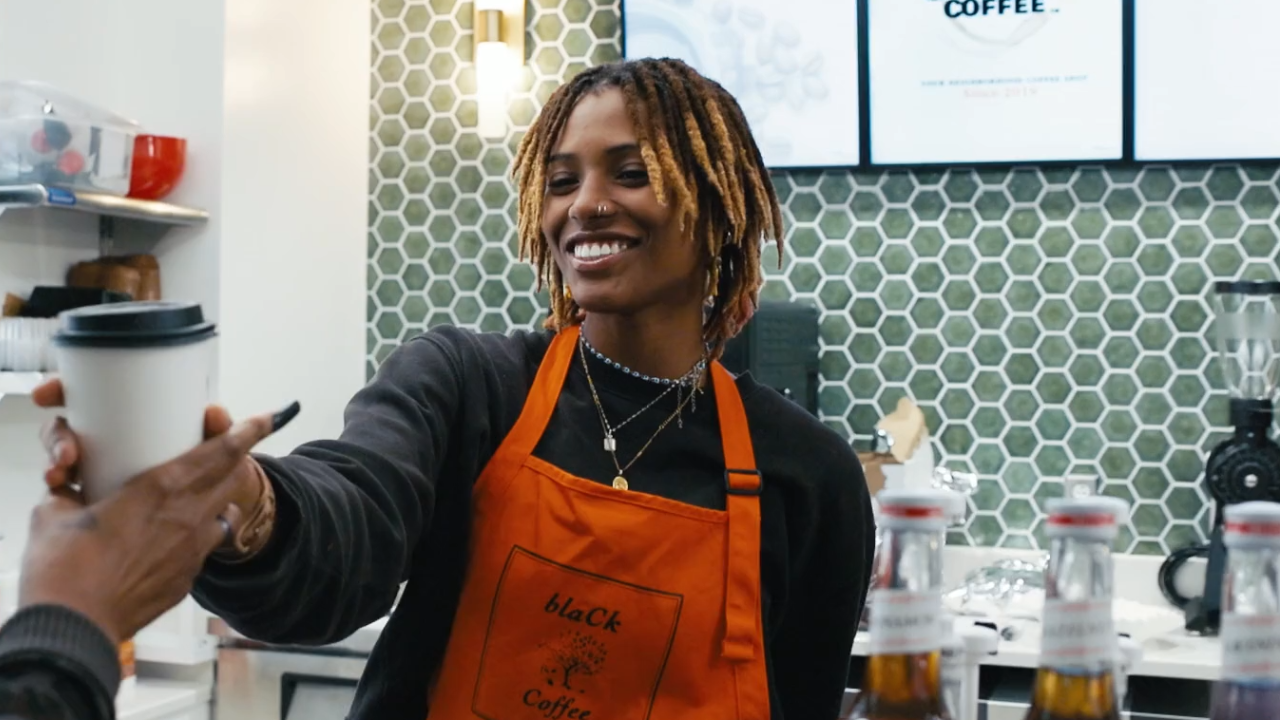 Team member at blaCk Coffee Lounge serves a guest at the UC Blood Cancer Center in Cincinnati, Ohio