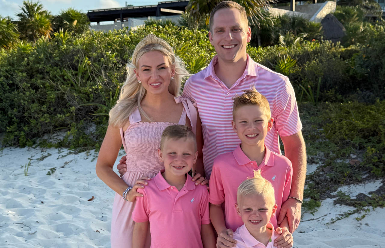 Brittany Beaver ,with her husband and sons, pose on the beach in their pink outfits