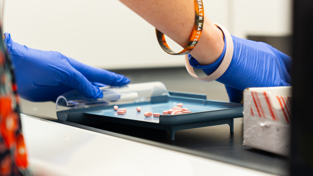 Researcher sorts pills for clinical trial