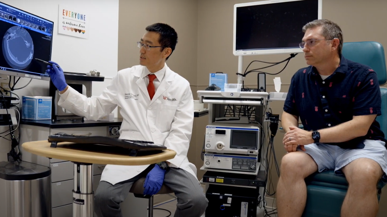Dr. Sun at UC Health reviews a hearing treatment with a patient 