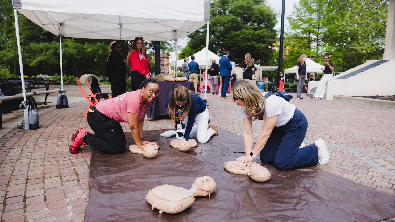 Participants learn hands-only CPR from UC Health instructors at a 513 Day event in Cincinnati