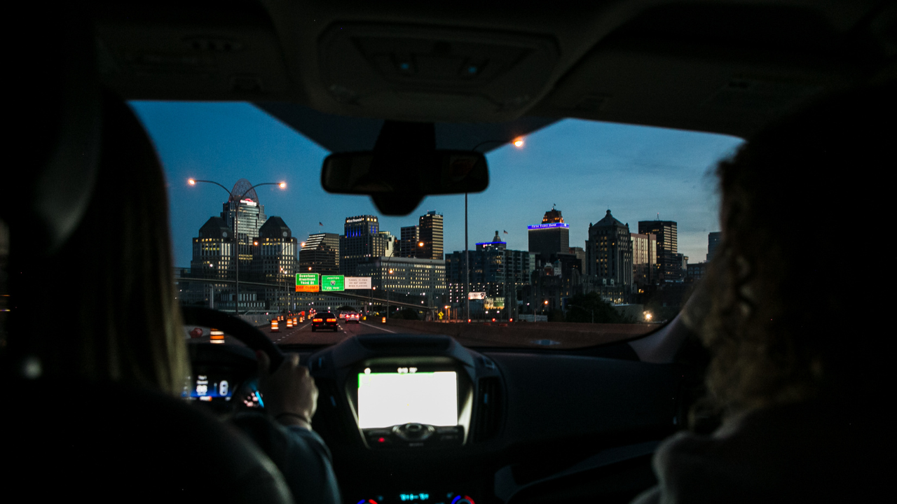 People in a car driving to Cincinnati in the dark