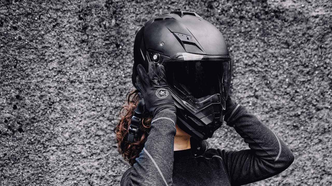 Woman puts on her motorcycle helmet