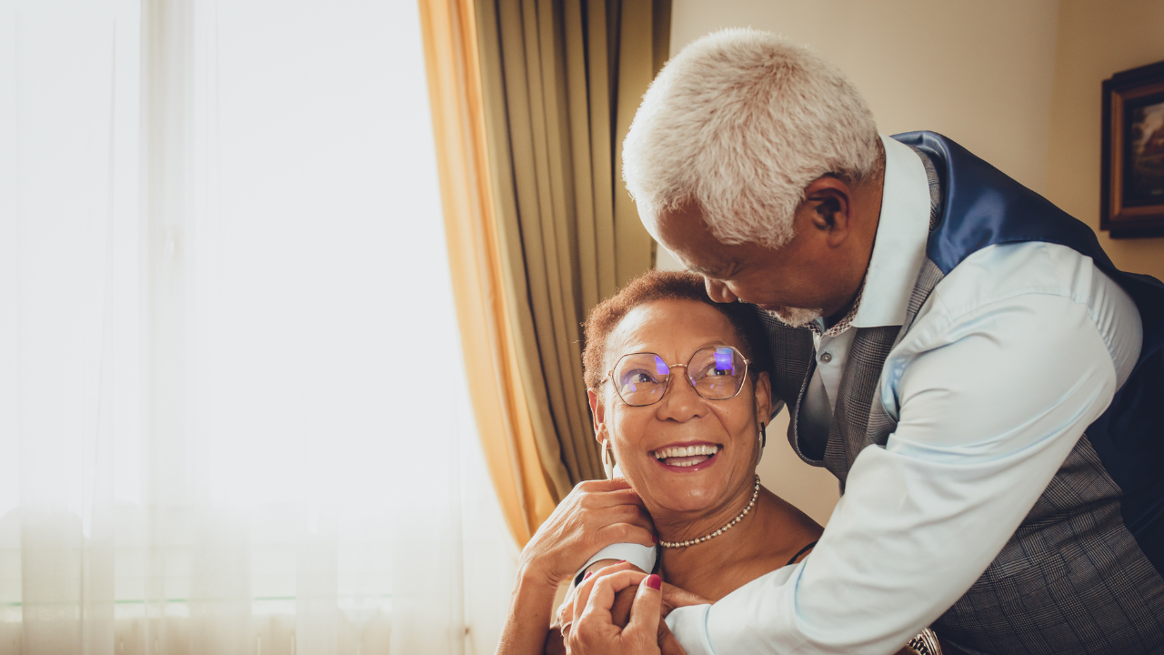Older couple smile and embrace