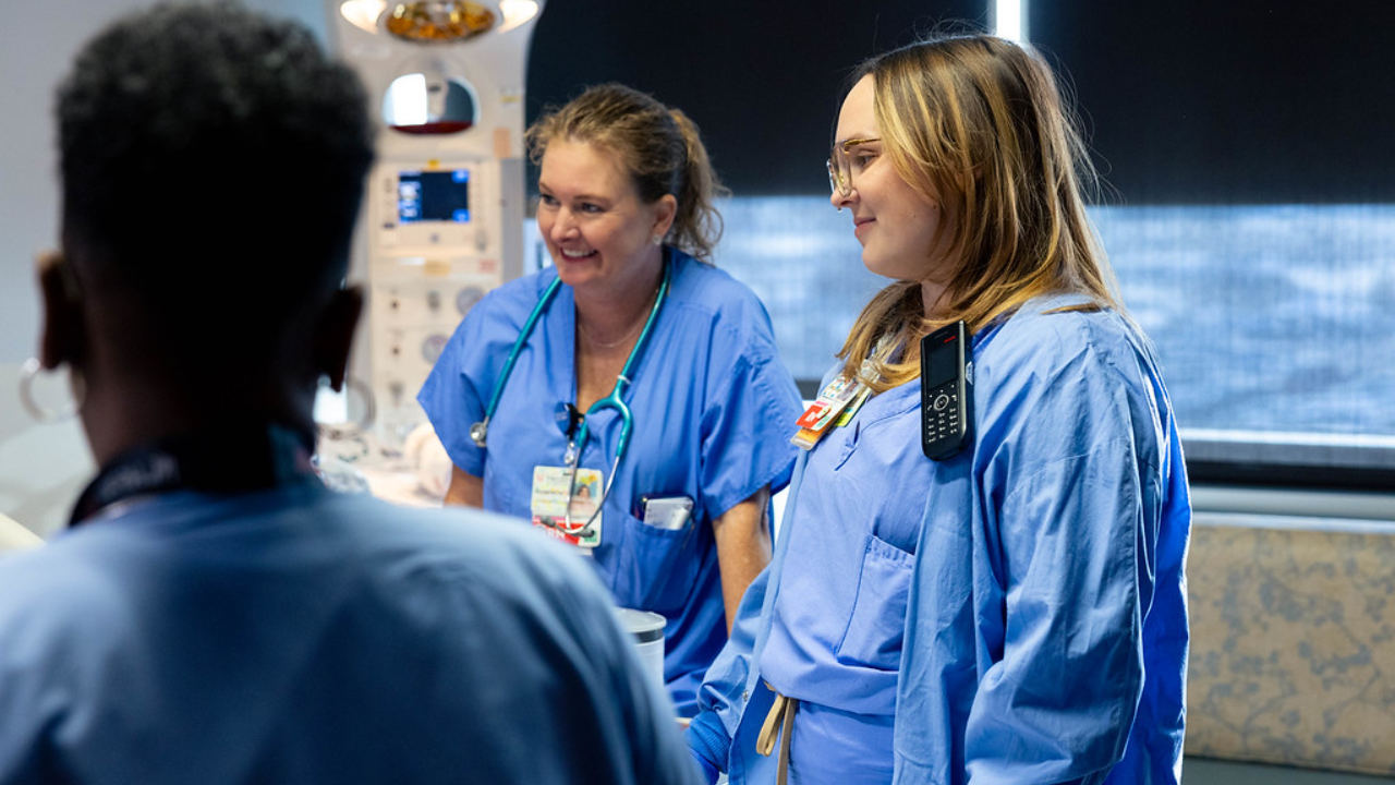 The care team at UC Health gathers around a patient in a birthing room
