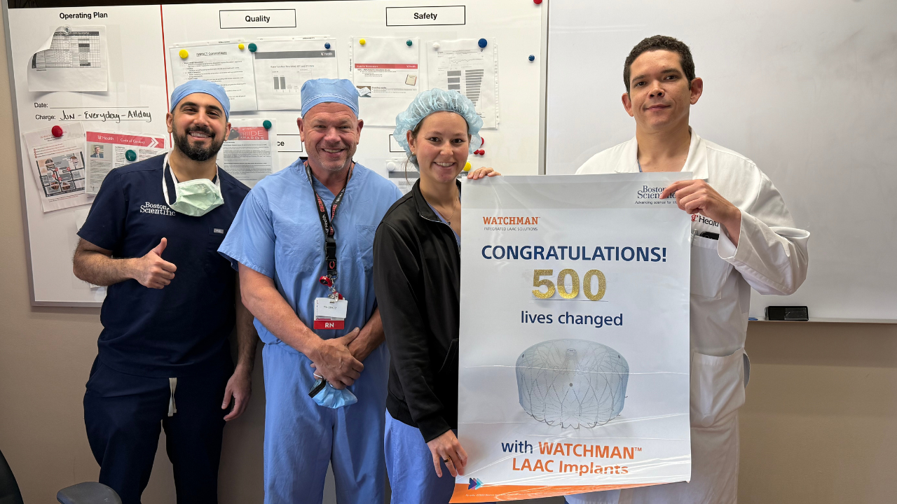 UC Health Team holds poster celebrating 500th WATCHMAN procedure