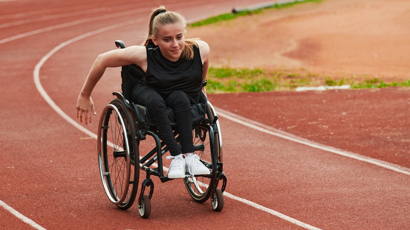 Woman uses wheelchair to race on a track