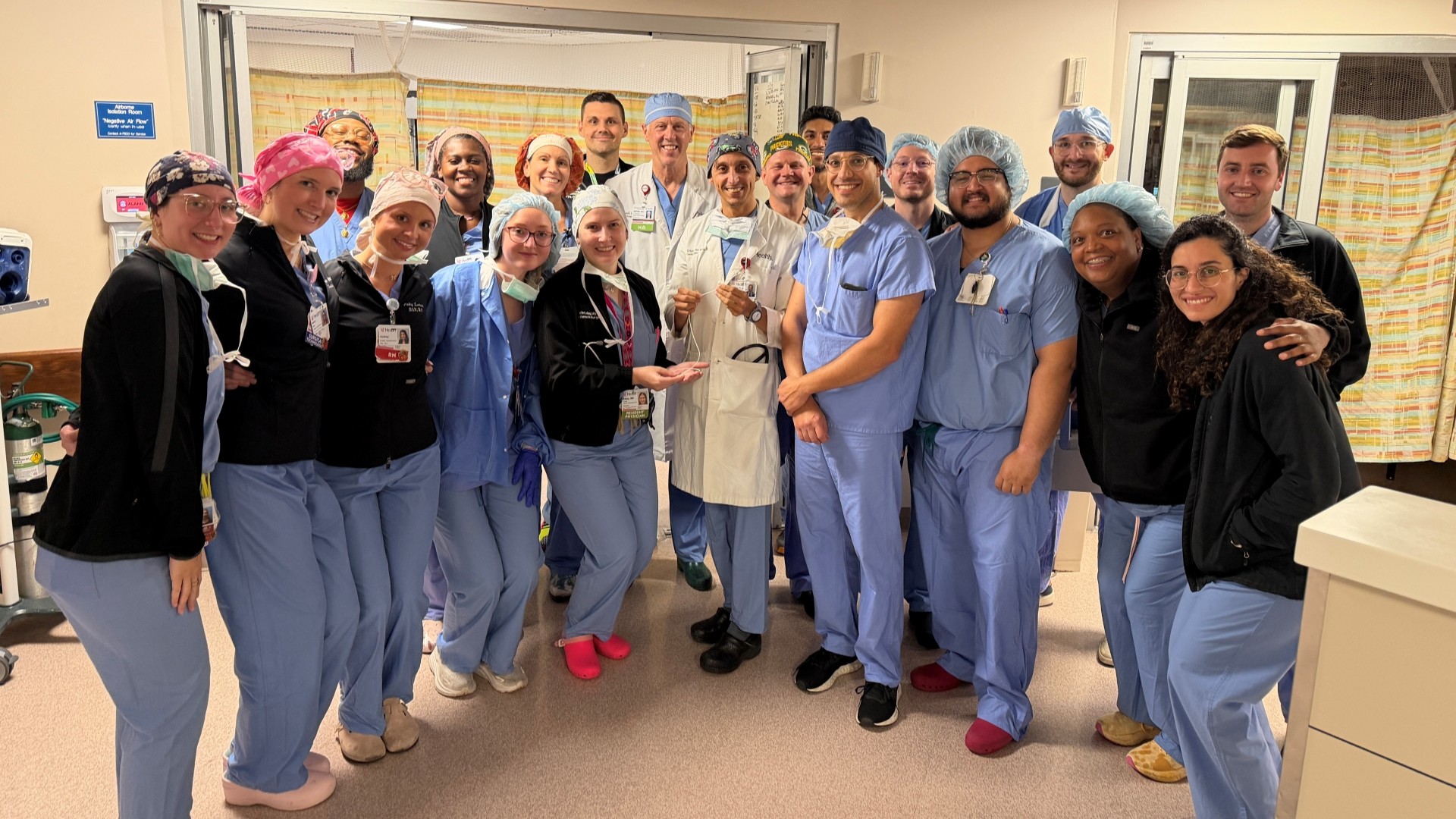 UC Health cardiac surgery team in scrubs in a medical environment. 