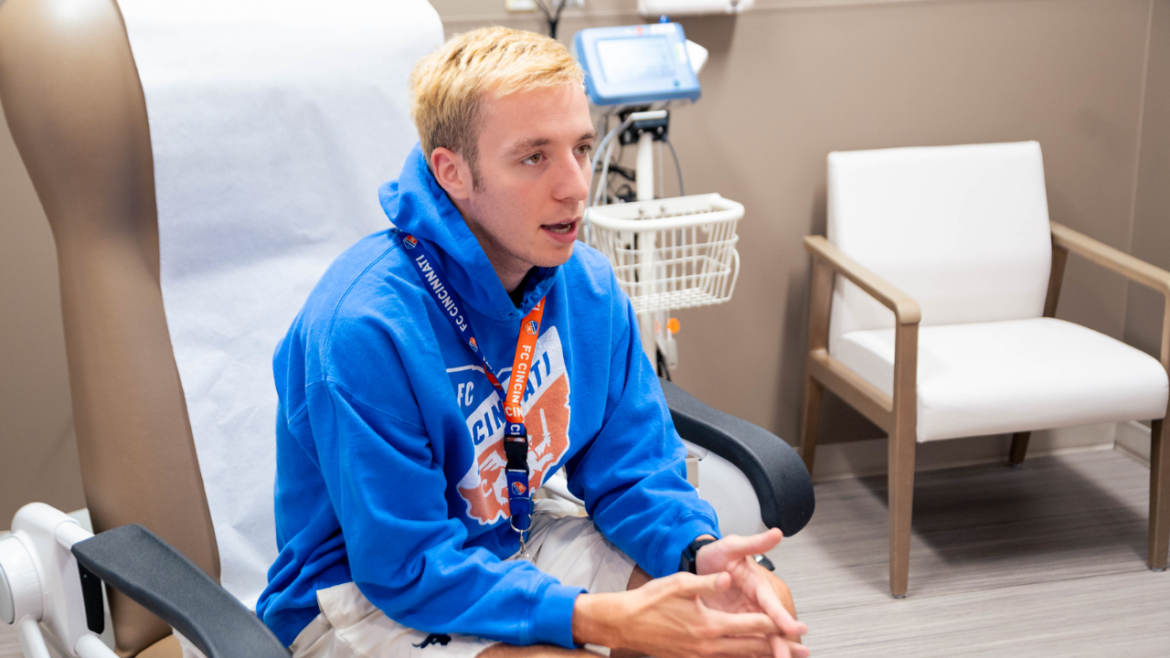 Patient sits in exam chair while meeting with care team at Epilepsy Center
