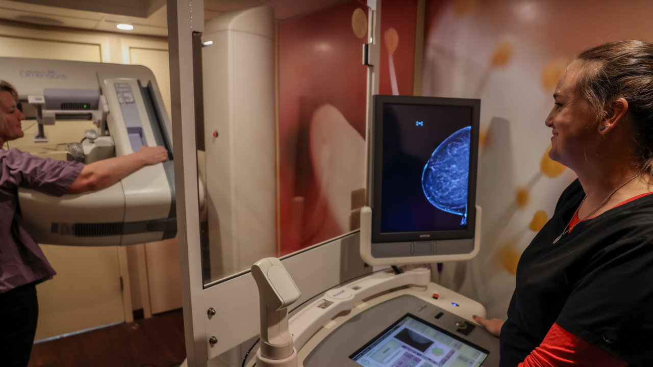 Mammogram technologist performs a mammogram on a patient in UC Health's mobile mammogram vehicle.
