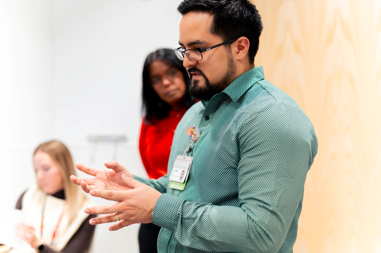 A group of physicians gather to discuss a case. 